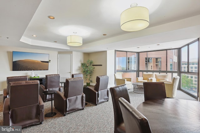 carpeted dining space featuring a tray ceiling and recessed lighting