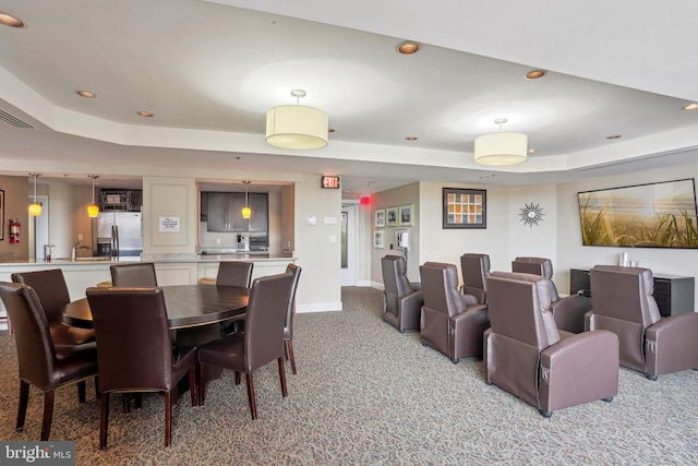 dining room featuring baseboards, a tray ceiling, recessed lighting, and light colored carpet