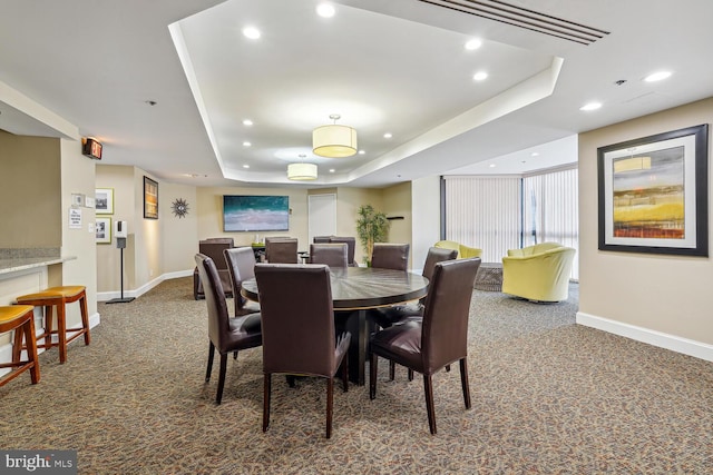 dining space with recessed lighting, carpet, a raised ceiling, and baseboards