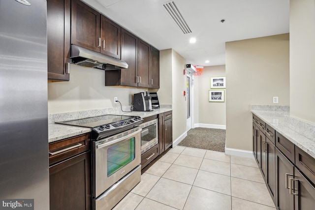 kitchen with visible vents, appliances with stainless steel finishes, dark brown cabinets, light stone countertops, and under cabinet range hood