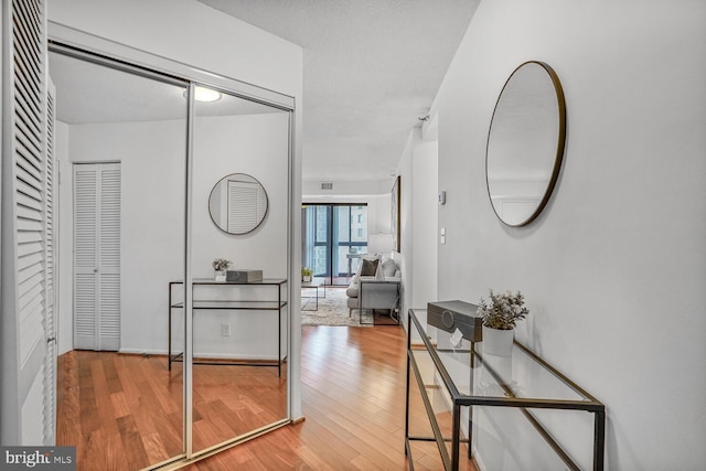 hallway with hardwood / wood-style floors