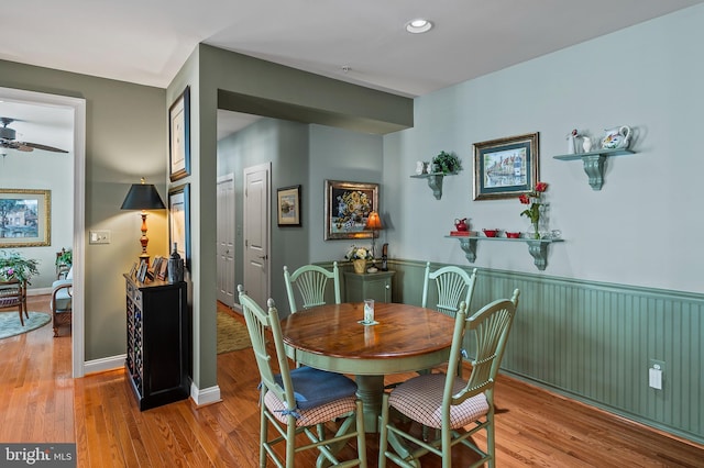 dining space with recessed lighting, light wood finished floors, ceiling fan, and wainscoting