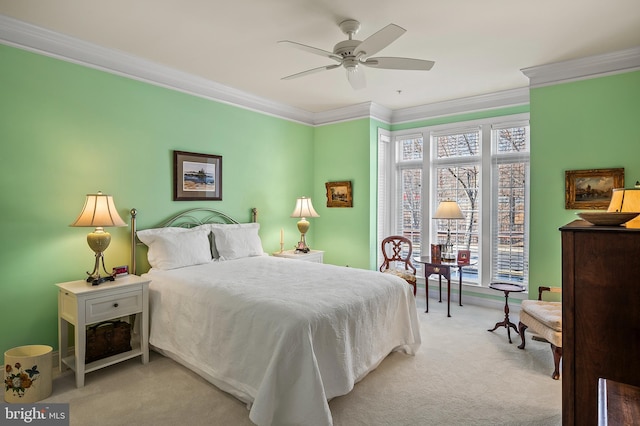 bedroom featuring carpet, ornamental molding, and ceiling fan