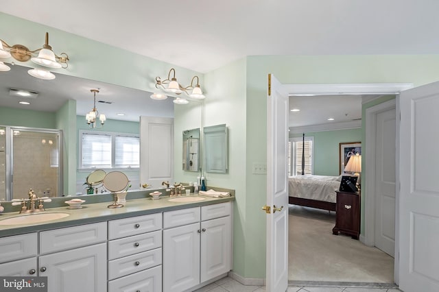 bathroom with a stall shower, a sink, ensuite bathroom, and double vanity