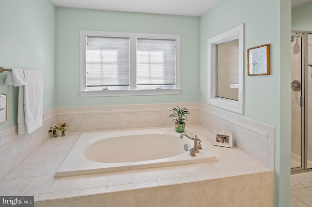 bathroom with a stall shower and a garden tub