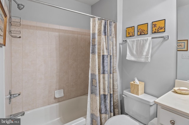 bathroom with vanity, shower / bath combo with shower curtain, and toilet