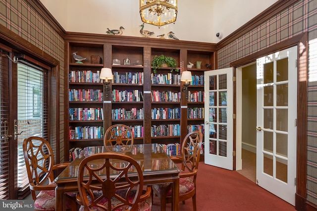 carpeted dining space featuring a chandelier and french doors