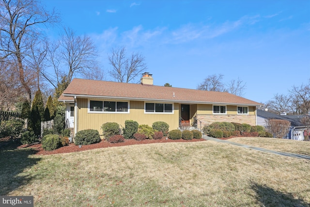 single story home with a front lawn and a chimney