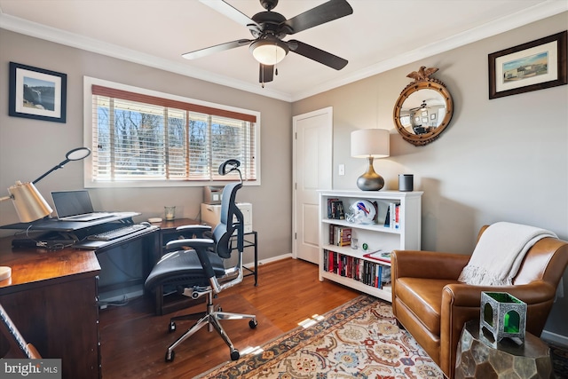 office area with ornamental molding, a ceiling fan, baseboards, and wood finished floors