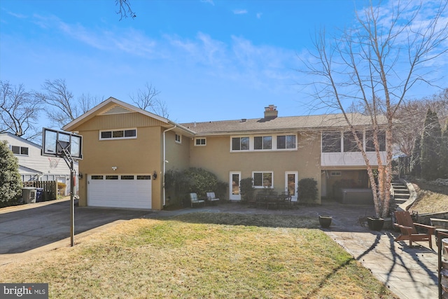 view of front facade featuring a chimney, stucco siding, an attached garage, driveway, and a front lawn