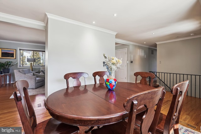 dining space featuring ornamental molding, wood finished floors, visible vents, and recessed lighting