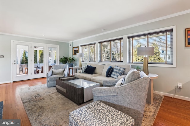 living room with crown molding, hardwood / wood-style flooring, and a healthy amount of sunlight