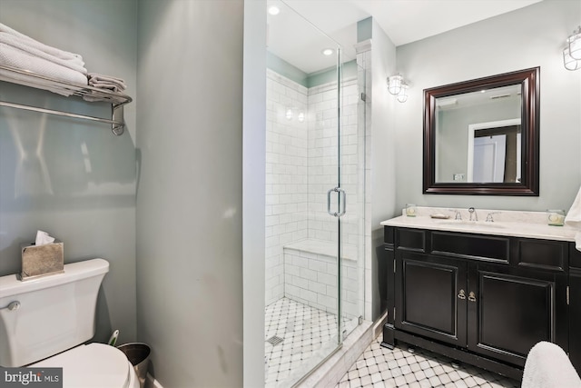 full bath featuring toilet, a shower stall, and vanity