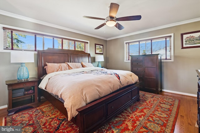 bedroom with dark wood-style floors, baseboards, and crown molding