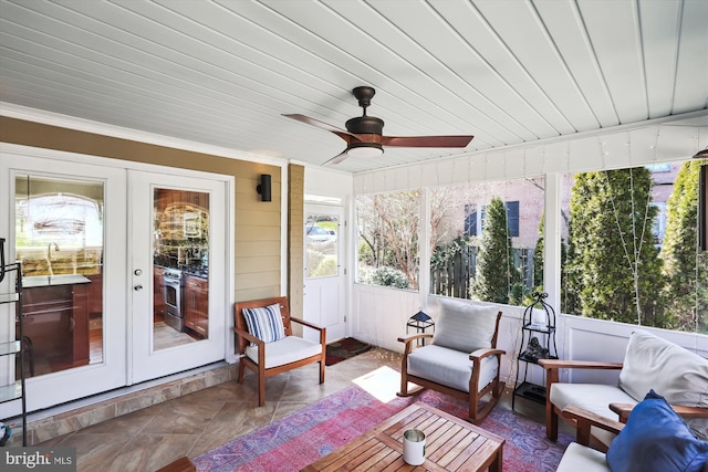 sunroom featuring ceiling fan, french doors, and wooden ceiling