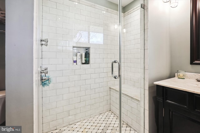 bathroom featuring a shower stall and vanity