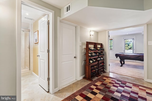 corridor featuring baseboards and visible vents