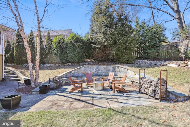 exterior space with fence and a fire pit