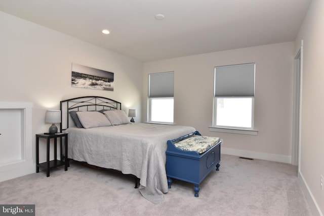 bedroom with recessed lighting, light colored carpet, visible vents, and baseboards