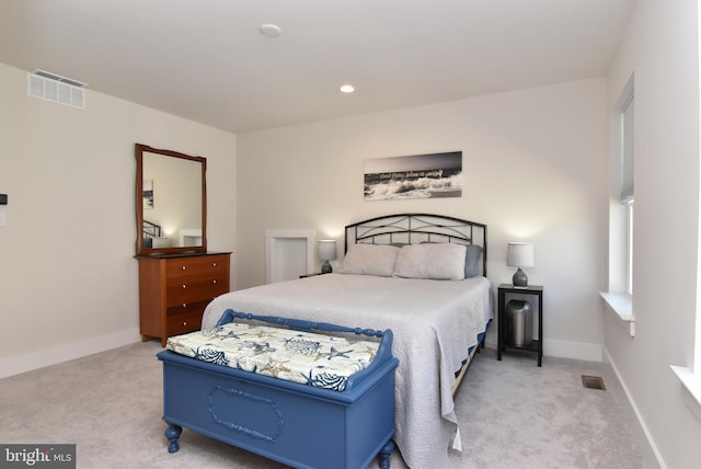 carpeted bedroom with recessed lighting, visible vents, and baseboards