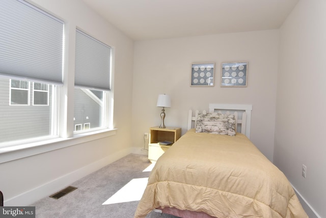 bedroom featuring carpet flooring, visible vents, and baseboards