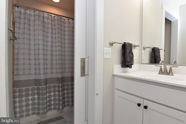 full bath with a shower with shower curtain and vanity