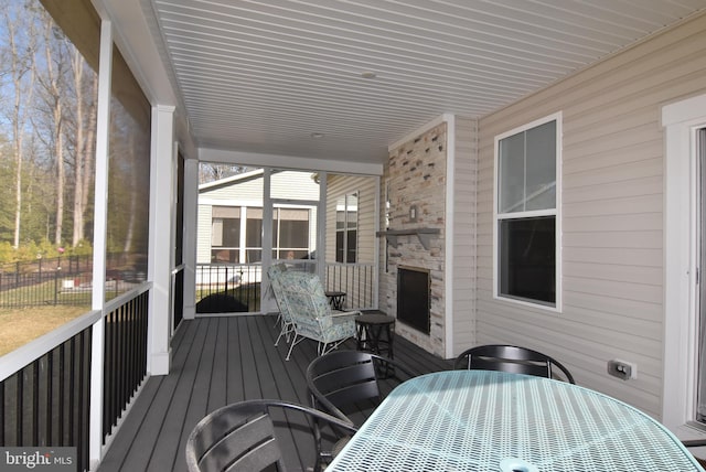 wooden deck with outdoor dining space and fence