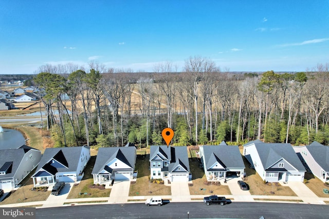 bird's eye view featuring a residential view and a view of trees