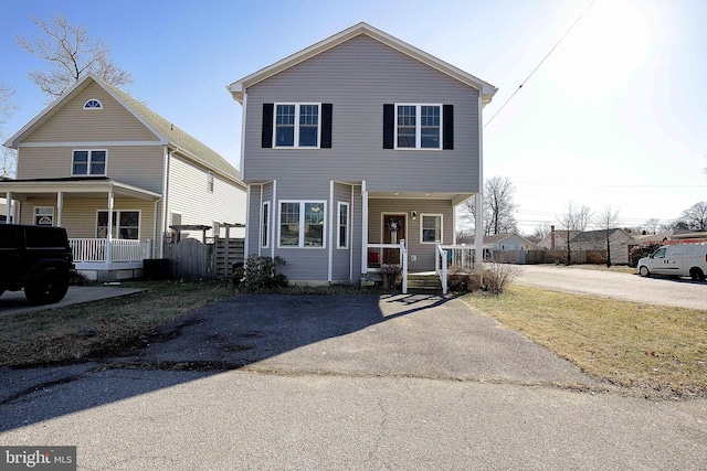 traditional home with aphalt driveway and a porch