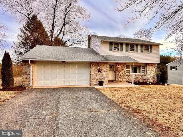 traditional-style home featuring a garage, stone siding, a shingled roof, and aphalt driveway