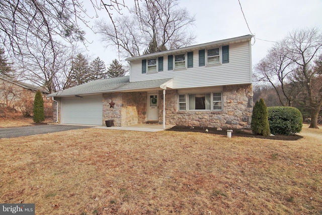 view of front facade with aphalt driveway, a front yard, stone siding, and a garage