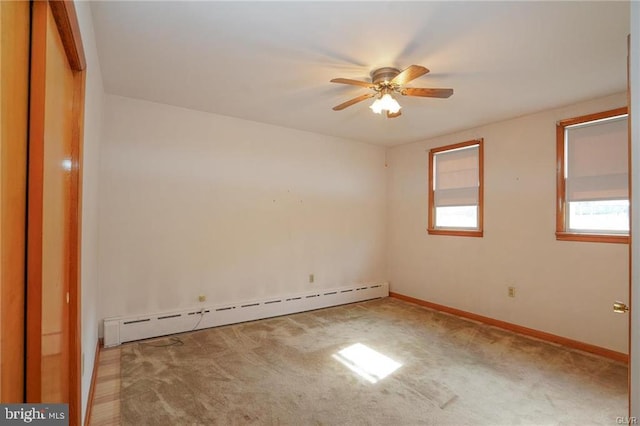 unfurnished room featuring ceiling fan, a baseboard radiator, light carpet, and baseboards