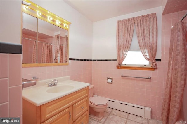 full bath with toilet, a baseboard radiator, tile patterned flooring, vanity, and tile walls