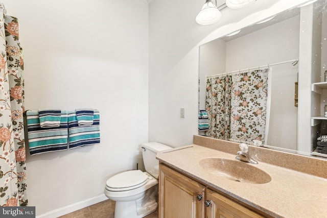 bathroom featuring tile patterned flooring, baseboards, vanity, and toilet