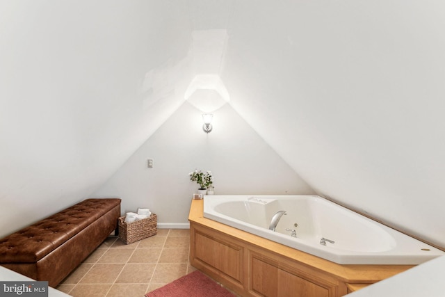 full bathroom with lofted ceiling, tile patterned flooring, and a tub with jets