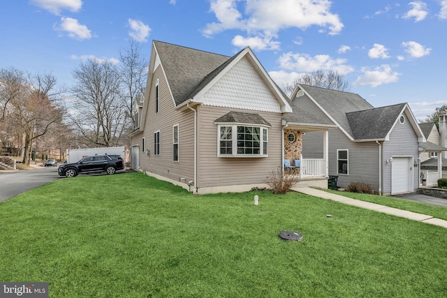 view of front of home featuring driveway, a porch, and a front lawn