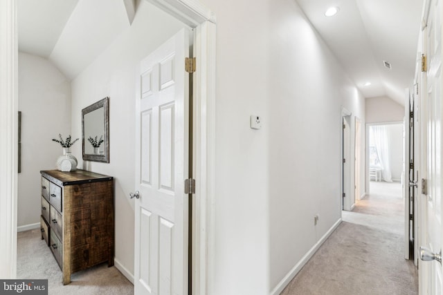 hallway with recessed lighting, light carpet, vaulted ceiling, and baseboards