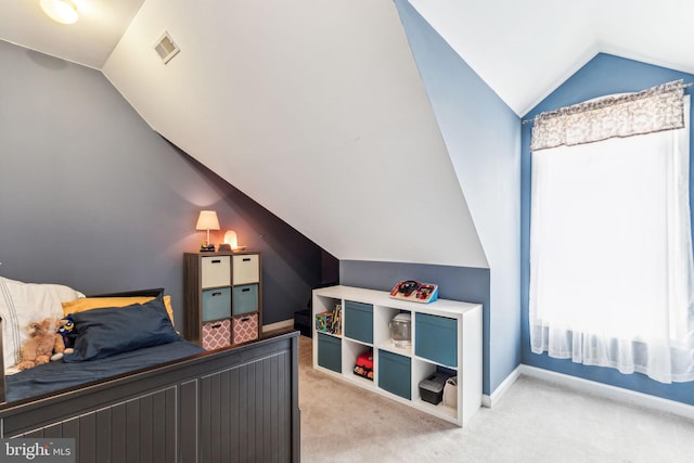 bedroom featuring light colored carpet, vaulted ceiling, visible vents, and baseboards