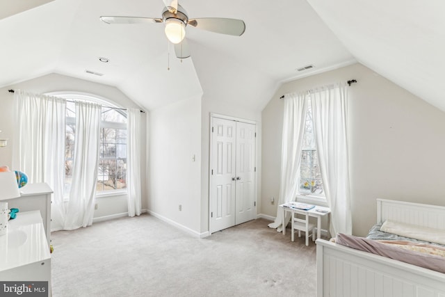 bedroom with light carpet, a ceiling fan, visible vents, vaulted ceiling, and baseboards