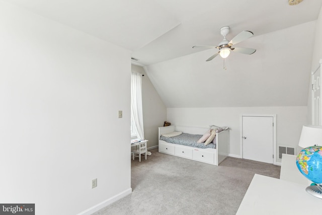 carpeted bedroom featuring visible vents, vaulted ceiling, baseboards, and ceiling fan