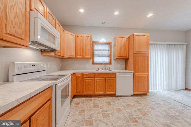 kitchen featuring recessed lighting, white appliances, a sink, light countertops, and stone finish flooring