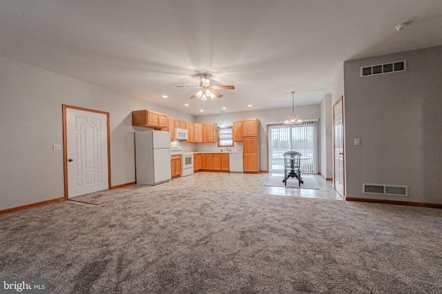 kitchen with white appliances, baseboards, visible vents, and light colored carpet