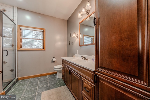 bathroom with baseboards, toilet, tile patterned floors, vanity, and a shower stall