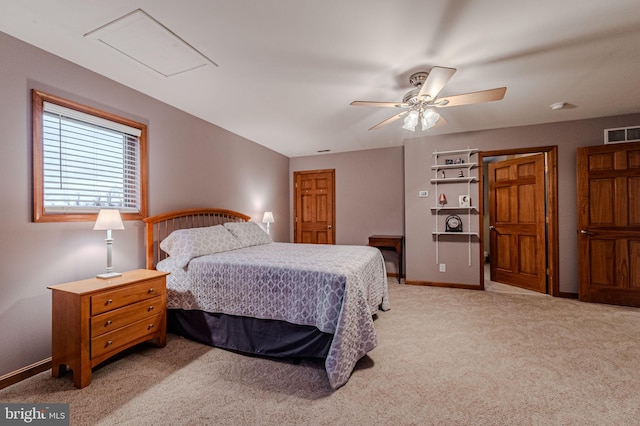 bedroom featuring visible vents, attic access, a ceiling fan, light carpet, and baseboards