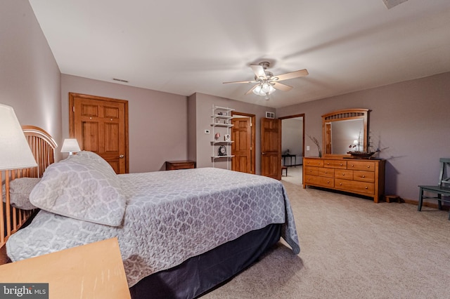 bedroom with ceiling fan, baseboards, visible vents, and light colored carpet