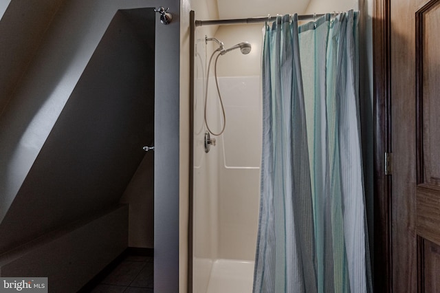 bathroom with a shower with shower curtain and tile patterned floors