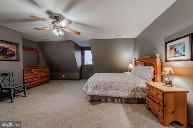 bedroom featuring lofted ceiling, ceiling fan, carpet flooring, and visible vents