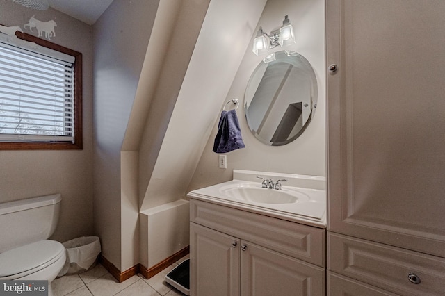 bathroom featuring toilet, vanity, baseboards, and tile patterned floors