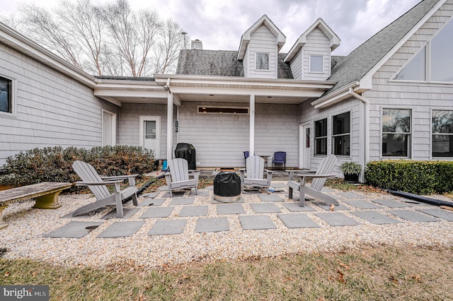 view of patio / terrace featuring an outdoor fire pit and grilling area