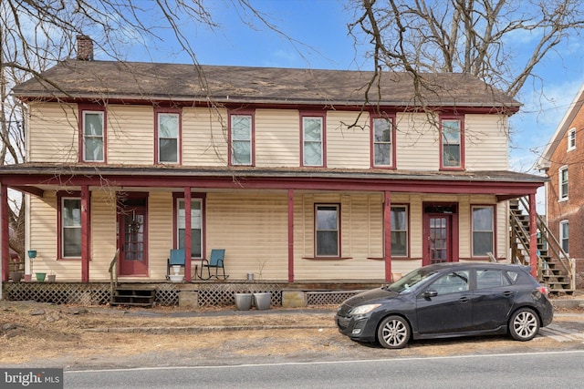 view of front of property with covered porch and a chimney